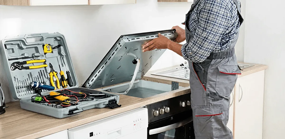Handyman repairing a cooktop and checking wiring connections in Pembroke Pines, FL