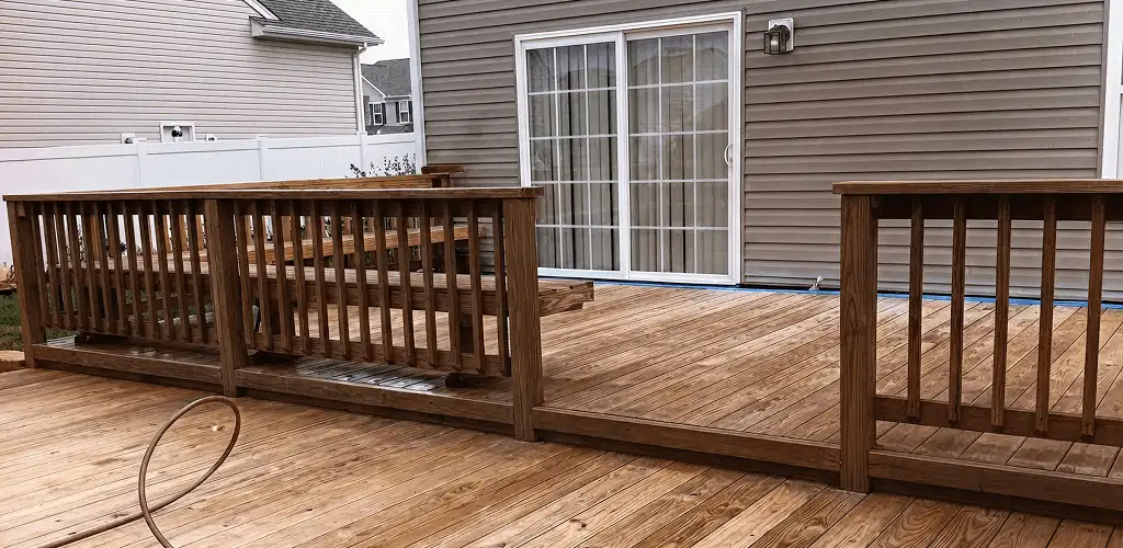 Deck sealing service protecting a backyard wood deck and railings in Pembroke Pines, FL