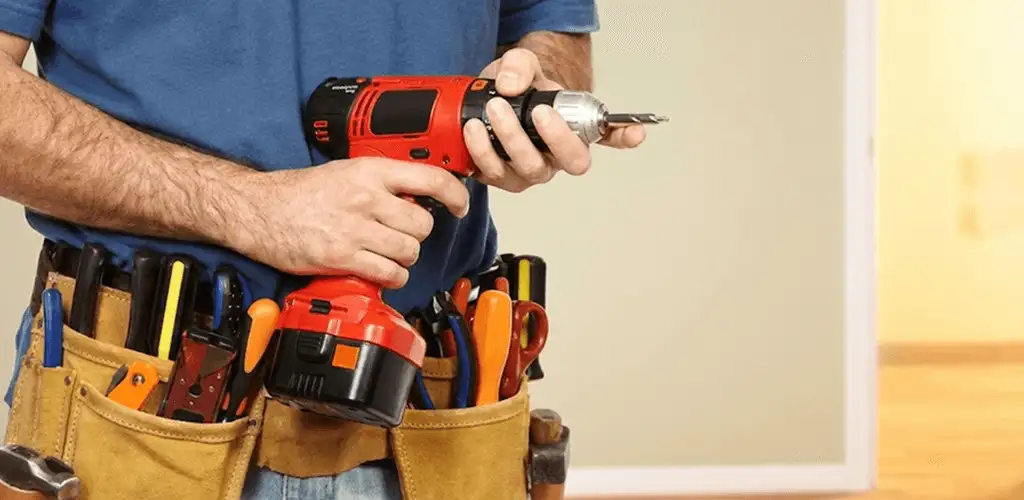 Handyman holding a power drill for home repairs and installations in Pembroke Pines, FL