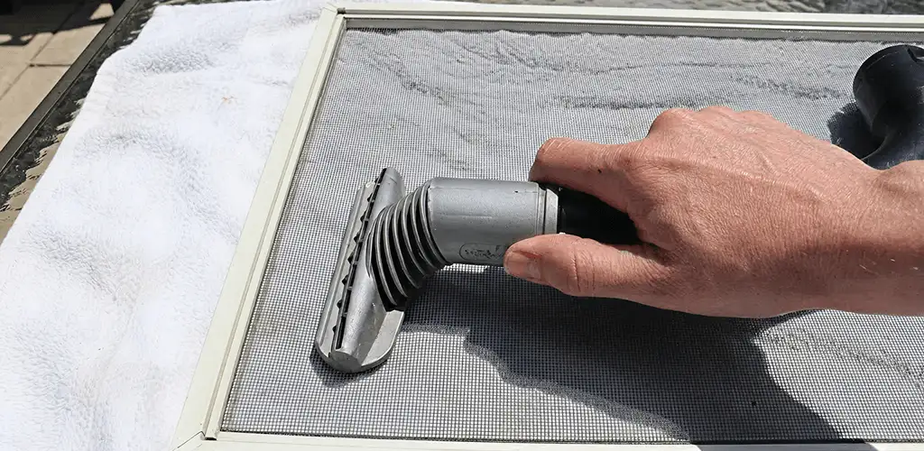 Window screen repair cleaning and fixing a damaged screen mesh in Pembroke Pines, FL